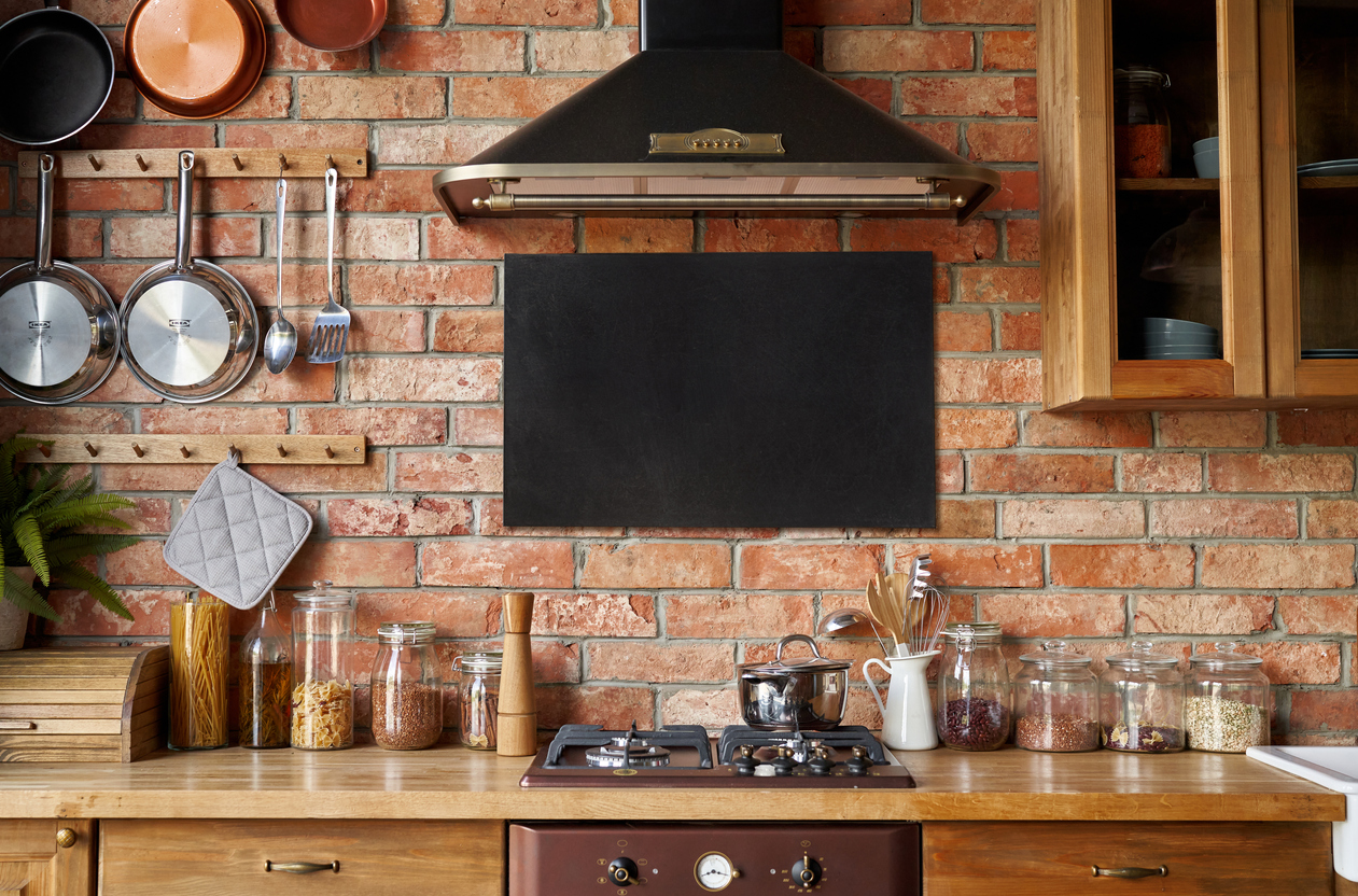 2) Traditional, elegant kitchen with rich wood cabinets and a brick backsplash. 