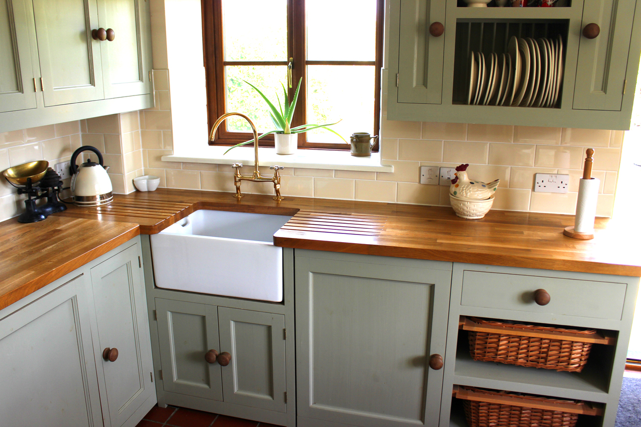 Cozy cottage kitchen with shaker cabinets and a farmhouse sink.